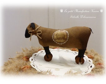 Nostalgic old flour sack decoration sheep on wooden wheel Primitive Art Folk Shabby Chic, vintage, country house style,