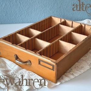 Old wooden drawer with compartments