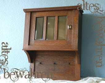 Antique hanging cabinet with hooks