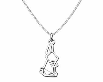 May include: A silver-colored necklace featuring a geometric pendant in the shape of a rabbit. The pendant is made of interconnected lines, creating a modern, minimalist design. The necklace has a delicate chain.
