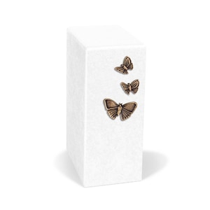 May include: White rectangular urn with three bronze butterfly accents.