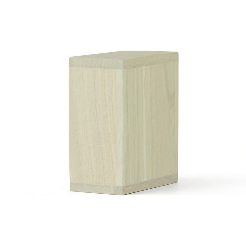 May include: A light-colored, rectangular wooden box with a slightly angled top. The box is made of light-colored wood with visible grain patterns. The design is simple and modern, with clean lines and a minimalist aesthetic.