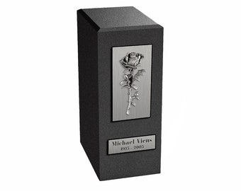 May include: Black granite urn with a silver rose design and a silver plaque with the text "Michael Viens 1935 - 2005".