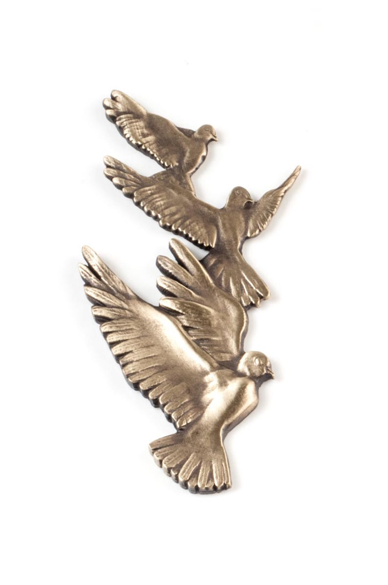 May include: A decorative wall hanging featuring three bronze-colored birds in flight, arranged in a vertical formation. Each bird is depicted with wings spread wide, showing detailed feather textures and a metallic finish with dark highlights.