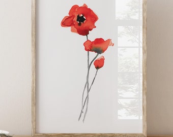 May include: A framed watercolor painting of red poppies on a white background. The painting is in a light wood frame and is sitting on a wooden shelf.