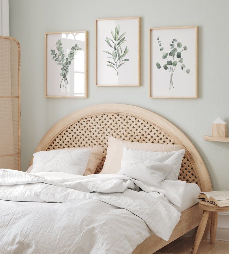 Watercolor minimalist greenery set depicting eucalyptus and olive branch, bedroom wall decor over a queen size bed.