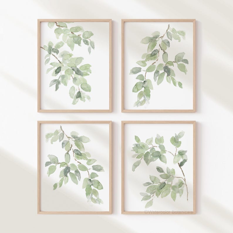 May include: Set of four watercolor prints featuring green leaves on a white background. Each print is framed in a light wood frame.