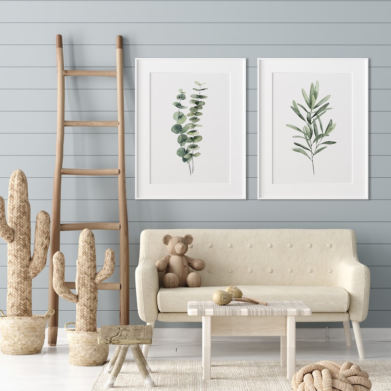 Green hand painted watercolor eucalyptus and olive branch hanging in a modern baby girl nursery. The posters come in all sizes. 
All fine art prints have unbeatable quality.