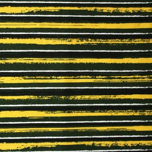 Könnte beinhalten: Nahaufnahme eines gelb-grünen gestreiften Stoffes mit einem weißen Maßband am rechten Rand. Das Band zeigt die Zahlen von 17 bis 39.