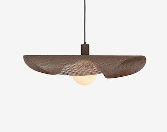 May include: A modern pendant light fixture with a brown, perforated shade and a spherical, frosted glass bulb. The shade has a unique, wavy design. The light hangs from a black cord and is suspended from a cylindrical fixture.
