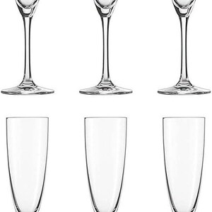 May include: Six clear champagne flutes with tall, slender stems and a classic, elegant design. The glasses have a long, narrow bowl, perfect for showcasing the bubbles of sparkling wine. The flutes are arranged in two rows of three.