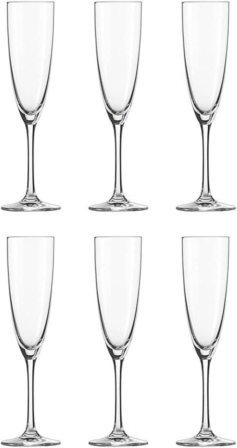 May include: Six clear champagne flutes with tall, slender stems and a classic, elegant design. The glasses have a long, narrow bowl, perfect for showcasing the bubbles of sparkling wine. The flutes are arranged in two rows of three.