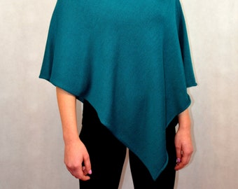 knitted asymmetrical poncho in turquoise color