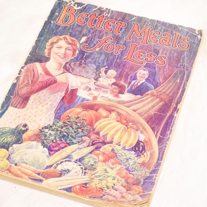 May include: Vintage cookbook cover titled "Better Meals for Less." The cover features a woman in an apron, a cornucopia overflowing with produce, and a family scene. The color palette includes warm tones of red, orange, and green.