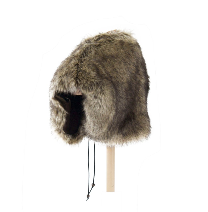 May include: A brown faux fur hat with a long, black drawstring. The hat has a wide brim and a pointed top.