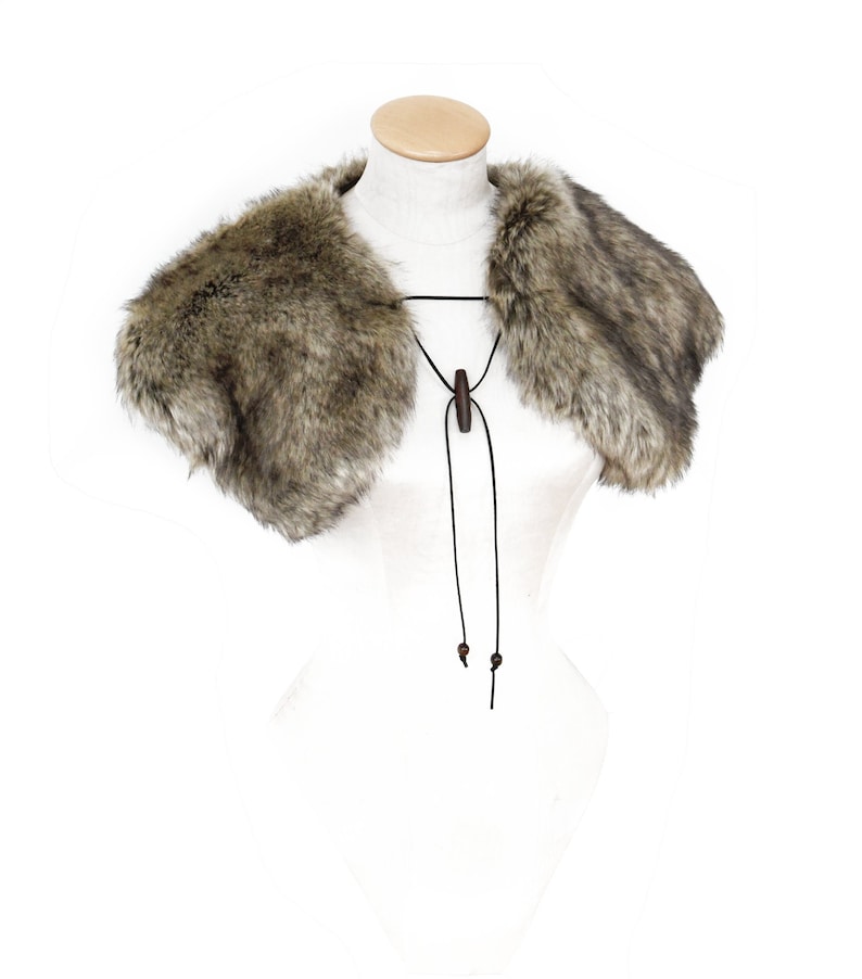 May include: A brown faux fur collar with a black leather tie and wooden toggle closure.