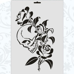May include: Black and white stencil of a skull with roses. The skull is facing to the right and has a detailed design. The roses are in full bloom and have a delicate design.