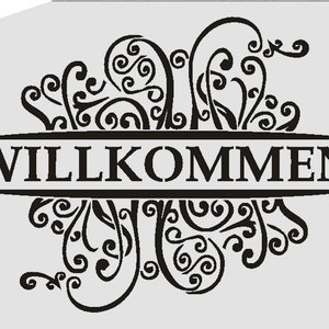 May include: Black and white decorative stencil with a floral design and the word "WILLKOMMEN" in a banner.