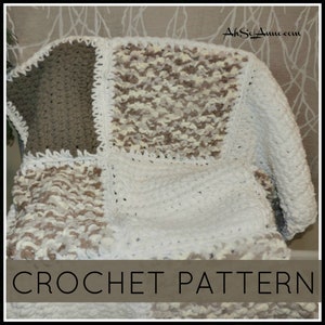 May include: A crochet blanket with a patchwork design in white, brown, and beige. The blanket is made with a chunky yarn and has a crocheted border. The text "CROCHET PATTERN" is at the bottom of the image.
