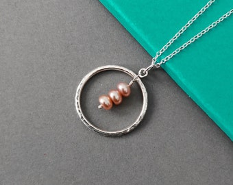 Sterling silver and pink pearl necklace | Handmade hammer textured recycled silver circle and pale pink pearl pendant on an 18 inch chain