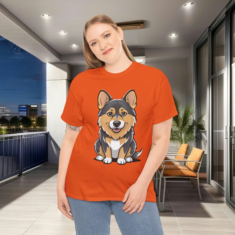 May include: Orange plus size t-shirt featuring a cartoon illustration of a corgi dog. The corgi is predominantly black and tan. The shirt is a comfortable, casual style, suitable for everyday wear.  The design is simple yet eye-catching, making it a fun and fashionable choice.