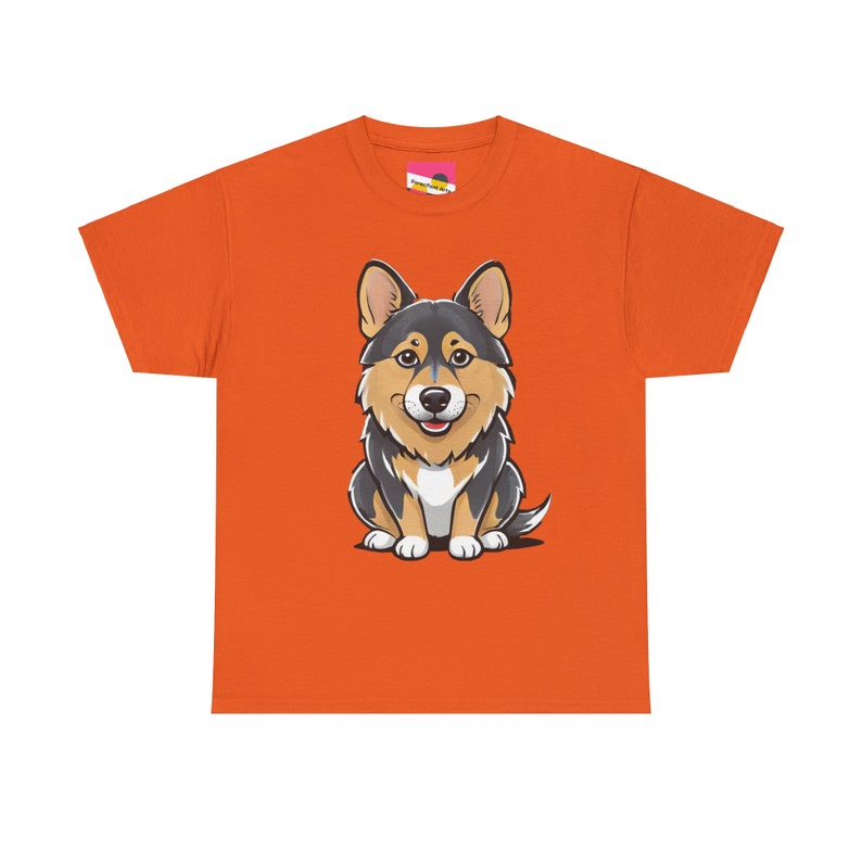 May include: Orange t-shirt featuring a cartoon corgi. The corgi is predominantly black and tan, sitting and facing forward. The shirt is a simple, short-sleeved crew neck style.  The design is centered on the shirt.