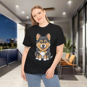 May include: Black plus size t-shirt featuring a cartoon illustration of a corgi dog. The corgi is predominantly black and tan, sitting and facing forward. The image is centered on the shirt. The shirt appears to be made of a soft, comfortable material suitable for everyday wear.