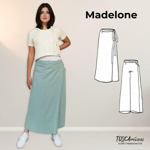 May include: A woman wearing a white cropped hoodie and a light green wrap skirt. The image also shows a line drawing of the skirt, labeled "Madeline" with the text "Toscamini Schnittmanufaktur".