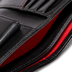 Black mens coin purse wallet with a striking red recycled lining. The lining is soft and durable and is made from 100% recycled plastic bottles.