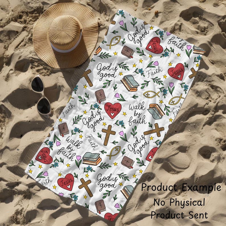 May include: White beach towel with a repeating pattern of religious symbols, including crosses, hearts, books, and fish. The towel also features the phrases "God is good", "Jesus", and "Walk by faith". A straw hat and sunglasses are next to the towel.
