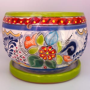 May include: A set of three ceramic nesting bowls in shades of blue, green, and white. The bowls feature a speckled glaze and a simple, modern design. The largest bowl measures approximately 8 inches in diameter.