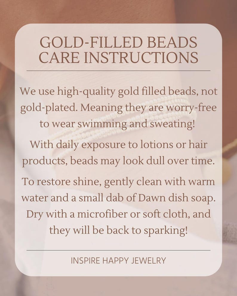 May include: A beige card with the text "GOLD-FILLED BEADS CARE INSTRUCTIONS" and care tips for gold-filled beads. The card advises cleaning with warm water and soap to restore shine. The brand name "INSPIRE HAPPY JEWELRY" is at the bottom.
