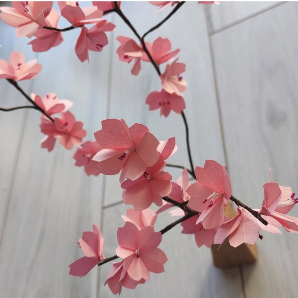 Japanese cherry tree branches in origami Pink sakura flowers for cherry blossom bouquet composition, wedding table decoration, baptism