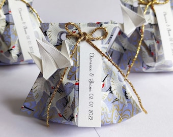 Lot of favor boxes in origami the flight of the lavender blue crane for wedding guest gifts and baptism table decoration