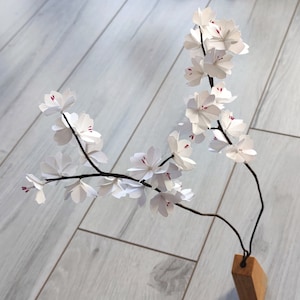 Japanese cherry blossom branches in origami White sakura flowers for flower bouquet arrangement, wedding table decoration, baptism