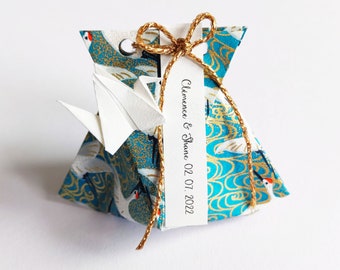 Set of origami candy boxes in flight of the turquoise blue crane for wedding guest gifts and baptism table decoration