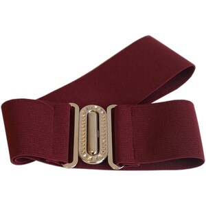 May include: A burgundy elastic belt with a silver-colored buckle. The belt is wide and has a textured appearance. The buckle is rectangular with a decorative design.