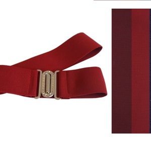 May include: A burgundy elastic belt with a silver-colored buckle. The belt is shown with a color swatch of burgundy, dark red, red, and navy blue fabric.