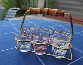 6 glasses in a brass stand with bamboo handle, colorful shot glasses in the frame
