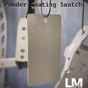 May include: A rectangular, brushed metal powder coating swatch suspended by a black wire. The text "Powder Coating Swatch" is displayed at the top. The LM Fabrication & Coating logo is visible in the lower right corner.