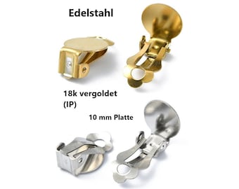 Puede incluir: Dos pares de clips para pendientes, un par es chapado en oro y el otro es plateado. Ambos pares tienen un diámetro de 10 mm y una forma plana y redonda. El texto "18k vergoldet (IP) 10 mm Platte" es visible en la imagen.