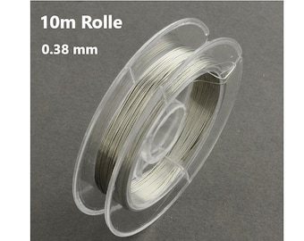 May include: A spool of silver-colored wire, 10 meters long and 0.38 millimeters thick, is wound around a clear plastic spool. The spool is labeled "10m Rolle 0.38 mm".
