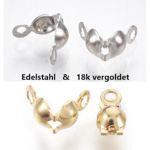 Könnte beinhalten: Nahaufnahme von Schmuckzubehör aus Edelstahl und 18k vergoldet. Die Zubehörteile haben eine abgerundete Form mit einer Schlaufe auf jeder Seite. Der Text "Edelstahl & 18k vergoldet" ist sichtbar.