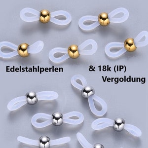 Könnte beinhalten: Zehn weiße Silikon-Brillenschlaufenhalter mit goldenen und silbernen Perlen.  Edelstahlperlen & 18k (IP) Vergoldung.