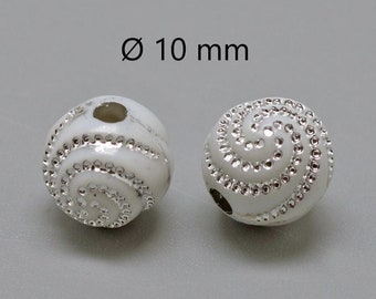 May include: Two white round beads with a silver swirl design and a hole through the center. The beads are 10 mm in diameter.
