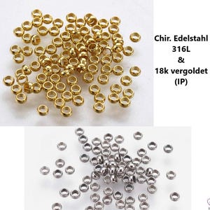 Könnte beinhalten: Eine Sammlung kleiner, goldfarbener und silberfarbener Metallringperlen. Die goldenen Perlen sind zusammengefasst, während die silbernen Perlen darunter verstreut sind. Der Text im Bild lautet "Chir. Edelstahl 316L & 18k vergoldet (IP)".