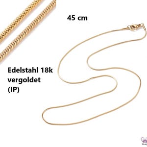 May include: A gold-coloured necklace, 45 cm long, with a snake chain design. The necklace is made of 18k gold-plated stainless steel. The text "Edelstahl 18k vergoldet (IP)" is visible.