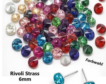 May include: A collection of colorful 6mm Rivoli Strass crystals in various colors, including red, blue, green, and pink. Two blue crystal stud earrings are also shown. Text on the image reads "Rivoli Strass 6mm" and "Für Kegelfassungen".