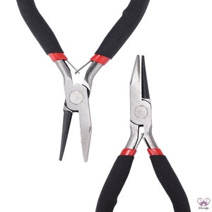 Puede incluir: Dos pares de alicates con mangos de goma negra y puntas rojas. Los alicates son de metal y tienen un acabado plateado.