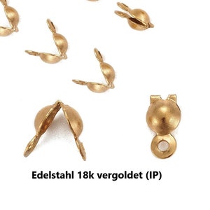 Könnte beinhalten: Goldfarbene Metallverschlüsse zum Schmuck basteln. Die Verschlüsse sind für die Verwendung mit Ketten oder Schnüren konzipiert. Die Verschlüsse sind aus Edelstahl mit einer 18 Karat Goldbeschichtung. Der Text "Edelstahl 18k vergoldet (IP)" ist im Bild sichtbar.